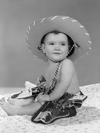 1960s baby girl wearing cowboy hat toy holsters and guns - Young Guns